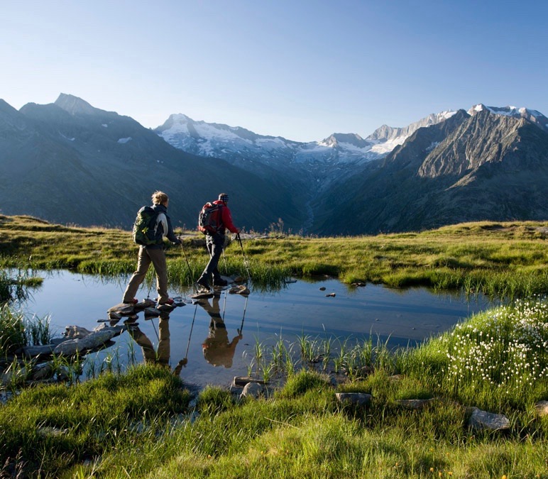 Two hikers in front of a beautiful mountain panorama