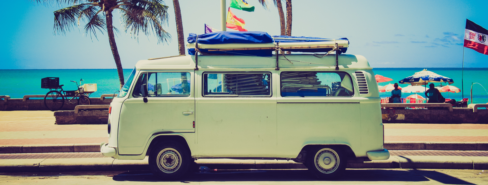 VW Bully van with holiday backdrop Image of VW Bully van with summer holiday backdrop