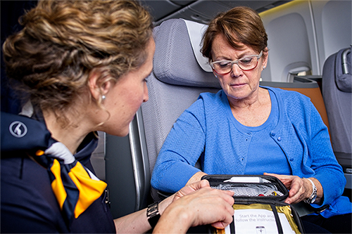 Flight attendant uses CardioSecur with a passenger.  