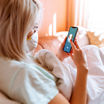 A mobile ECG can help to reduce the risk of infection with the new coronavirus COVID-19. Woman using the mobile ECG CardioSecur at home.